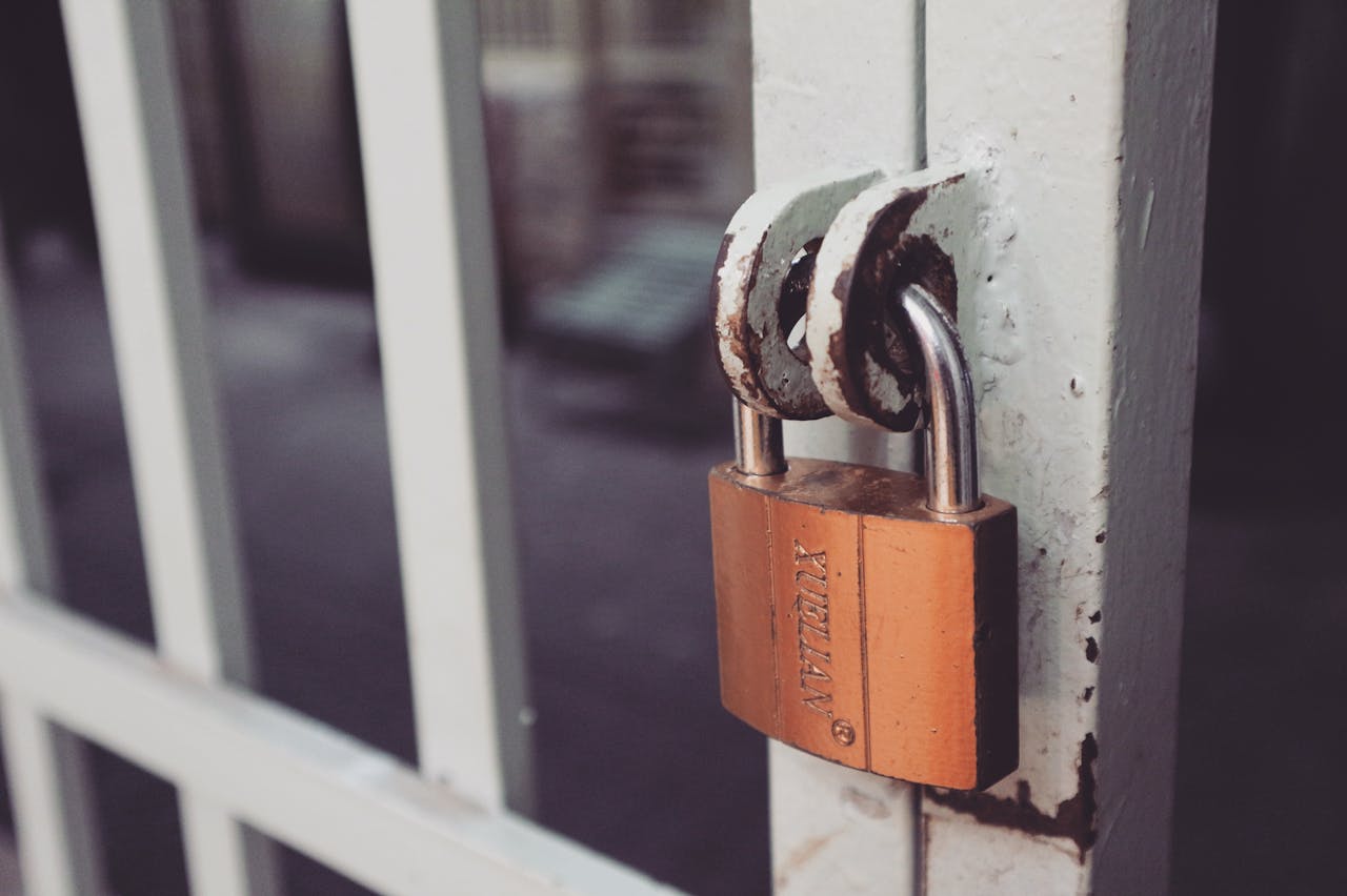 Padlock on a metal gate representing controlled access and rate limiting for login protection