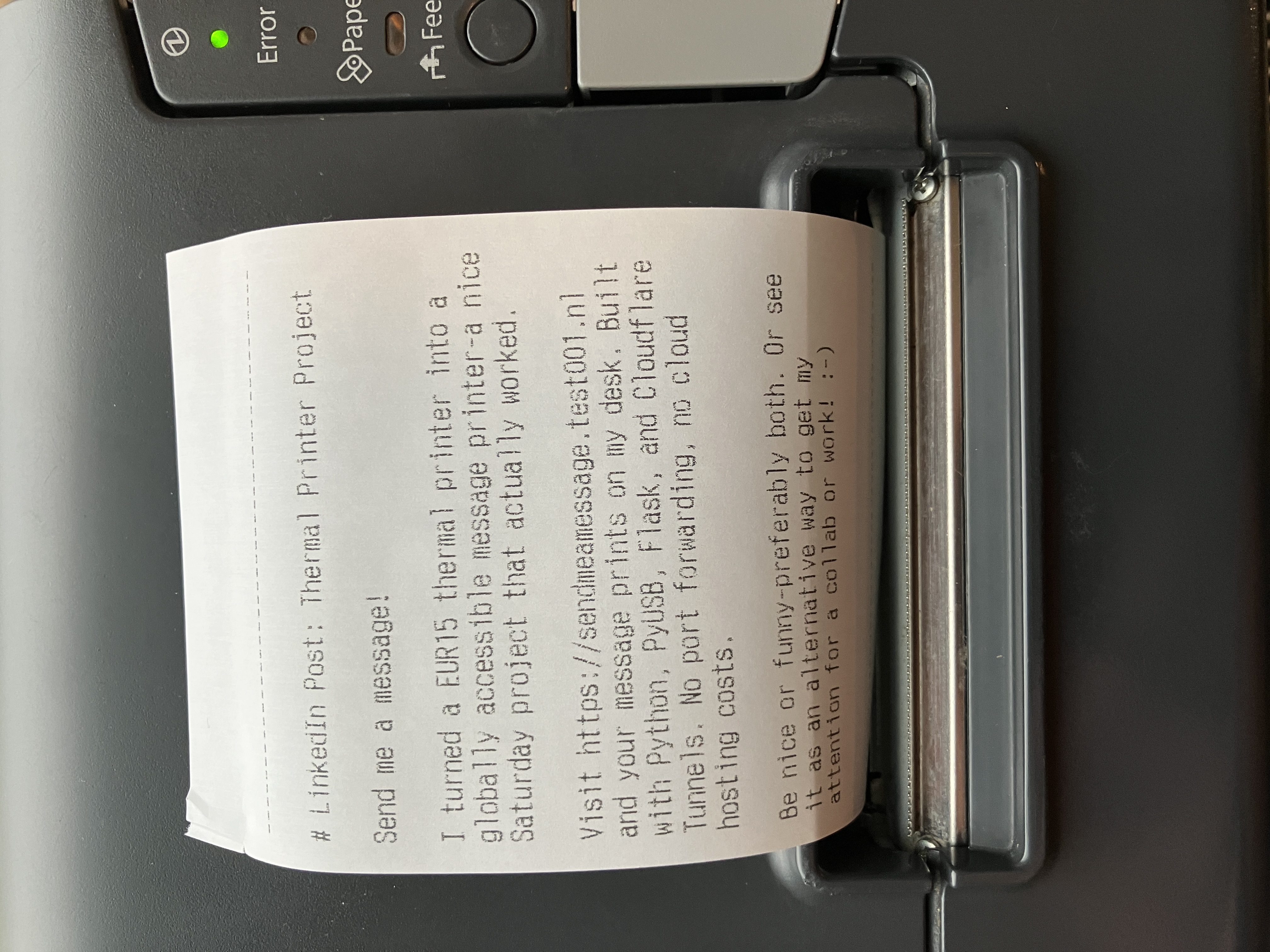 Thermal printer setup on desk showing printed message from web interface with Raspberry Pi